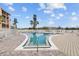 Inviting community pool with blue water surrounded by a spacious sundeck at 4126 Heron Way # B113, Bradenton, FL 34205