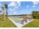 Enjoy a game of shuffleboard by the lake with benches and lush greenery at 4126 Heron Way # B113, Bradenton, FL 34205