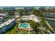 Aerial view of the community showing the pool, landscaping, and buildings at 4320 Falmouth Dr # 301, Longboat Key, FL 34228