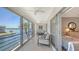 Enclosed balcony with comfortable seating, offering scenic waterfront views and ample light at 4320 Falmouth Dr # 301, Longboat Key, FL 34228