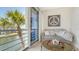 Inviting balcony with waterfront views, sliding glass doors, and cozy living room with stylish decor at 4320 Falmouth Dr # 301, Longboat Key, FL 34228