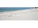 Wide, empty white sandy beach with calm turquoise ocean water and blue sky at 4320 Falmouth Dr # 301, Longboat Key, FL 34228