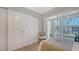 This bedroom features a sliding glass door with canal views and large white closets at 4320 Falmouth Dr # 301, Longboat Key, FL 34228