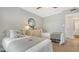 Bright bedroom features two twin beds, round mirror, and light wood laminate flooring at 4320 Falmouth Dr # 301, Longboat Key, FL 34228