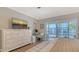 Comfortable bedroom with a dresser, computer desk, and access to a balcony with a view at 4320 Falmouth Dr # 301, Longboat Key, FL 34228