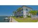 Waterfront condo building with lush landscaping, boat dock, and community pool at 4320 Falmouth Dr # 301, Longboat Key, FL 34228