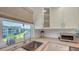 Well-lit kitchen area with stainless steel sink under a window showcasing the exterior landscape at 4320 Falmouth Dr # 301, Longboat Key, FL 34228