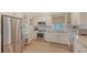 Modern kitchen featuring stainless steel appliances, bright white cabinetry, and tile flooring at 4320 Falmouth Dr # 301, Longboat Key, FL 34228
