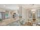 Open-concept kitchen with stainless appliances, white cabinets, and marble countertops at 4320 Falmouth Dr # 301, Longboat Key, FL 34228