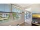 Bright living room with water views from two windows, and a view to the outdoor balcony at 4320 Falmouth Dr # 301, Longboat Key, FL 34228