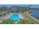 Inviting pool area with waterfront views, lounge chairs, and lush tropical landscaping, perfect for relaxing at 4320 Falmouth Dr # 301, Longboat Key, FL 34228