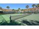 Outdoor tennis court with green surface, white lines, and surrounding condos at 4320 Falmouth Dr # 301, Longboat Key, FL 34228