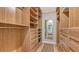 Spacious walk-in closet features custom shelving and drawers for ample storage and organization at 4320 Falmouth Dr # 301, Longboat Key, FL 34228