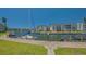 Scenic waterfront view showcasing multiple boat docks, lush lawns, and well-maintained condo buildings at 4320 Falmouth Dr # 301, Longboat Key, FL 34228
