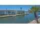 Picturesque waterfront view of a condominium complex with boats docked along the canal at 4320 Falmouth Dr # 301, Longboat Key, FL 34228