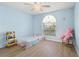 Charming bedroom with a large window providing plenty of natural light and wood laminate flooring at 5388 Pamela Wood Way # 8, Sarasota, FL 34233