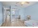 Bedroom with mirrored closet doors and a view to the hallway and out the front window at 5388 Pamela Wood Way # 8, Sarasota, FL 34233