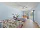 Spacious bedroom featuring two beds, light blue walls, and a sliding glass door to the outside at 5388 Pamela Wood Way # 8, Sarasota, FL 34233