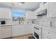 Bright kitchen featuring white cabinets, countertops, and new stainless steel appliances at 5388 Pamela Wood Way # 8, Sarasota, FL 34233