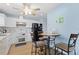 Stylish kitchen featuring a white cabinets, updated appliances, and a cozy breakfast nook at 5388 Pamela Wood Way # 8, Sarasota, FL 34233