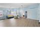 Spacious living room featuring light wood flooring, ample natural light, and a modern ceiling fan at 5388 Pamela Wood Way # 8, Sarasota, FL 34233