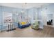 An airy living room featuring light wood flooring, neutral walls, and modern stylish furnishings at 5388 Pamela Wood Way # 8, Sarasota, FL 34233