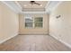 Bright, empty bedroom with wood floors, ceiling fan, and natural light at 6207 27Th E St, Ellenton, FL 34222