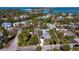A beautiful aerial view showcases the blue home, perfectly situated near the stunning coastal waters and beach at 651 Fox St, Longboat Key, FL 34228