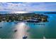 Majestic aerial shot captures the beauty of the coastline, complete with docks, boats and clear blue waters at 651 Fox St, Longboat Key, FL 34228