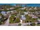 Scenic aerial view of a cozy neighborhood with lush landscaping, a calm bay and bridge in the distance at 651 Fox St, Longboat Key, FL 34228