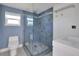 Bathroom featuring blue tiles, glass enclosed shower, and modern sink at 651 Fox St, Longboat Key, FL 34228