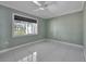 Bedroom features a ceiling fan, tile floors and a large window offering natural light at 651 Fox St, Longboat Key, FL 34228