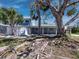 Attractive two-story blue house with covered porch and meticulous landscaping, adding to its curb appeal at 651 Fox St, Longboat Key, FL 34228