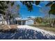 Charming two-story blue home with a gravel driveway and well-manicured front yard under a sunny blue sky at 651 Fox St, Longboat Key, FL 34228