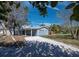 Charming blue two-story home featuring white trim, a gravel driveway, and mature trees at 651 Fox St, Longboat Key, FL 34228