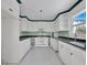 Well-lit kitchen with plenty of cabinet space and updated appliances at 651 Fox St, Longboat Key, FL 34228