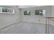 Spacious loft featuring natural light, wood floors, and railing at 651 Fox St, Longboat Key, FL 34228