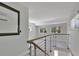 Upstairs loft area with railing and large windows offering lots of natural light at 651 Fox St, Longboat Key, FL 34228