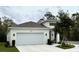 Gorgeous single-story home features a two-car garage, modern design, and a freshly landscaped yard at 1790 White Orchid Ct, Sarasota, FL 34235