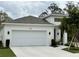 Beautiful one-story home boasting a spacious two-car garage, modern architecture, and manicured landscaping at 1790 White Orchid Ct, Sarasota, FL 34235