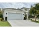 Charming single-story home with a two-car garage, modern design, and newly installed landscaping at 1790 White Orchid Ct, Sarasota, FL 34235