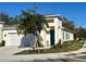 Inviting one-story home with a well-manicured lawn, blue door, and a modern exterior at 1790 White Orchid Ct, Sarasota, FL 34235