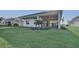 Spacious backyard with lush green lawn and covered patio at 17903 Palmiste Dr, Bradenton, FL 34202