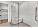 Modern bathroom featuring a glass-enclosed shower, freestanding tub, and tiled floor at 17903 Palmiste Dr, Bradenton, FL 34202