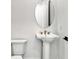 Modern bathroom featuring a pedestal sink with bronze fixtures and oval mirror at 17903 Palmiste Dr, Bradenton, FL 34202