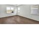 Well-lit bedroom features modern hardwood floors and large windows with views of the lake at 17903 Palmiste Dr, Bradenton, FL 34202