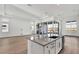 Well-lit kitchen featuring a large island with white cabinets and modern fixtures at 17903 Palmiste Dr, Bradenton, FL 34202