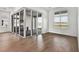 Bright open-concept living area with modern wood flooring and sliding glass doors to an outdoor cooking area at 17903 Palmiste Dr, Bradenton, FL 34202