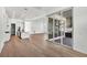 Open-concept living space with hardwood floors and a sliding glass door that opens to an outdoor kitchen at 17903 Palmiste Dr, Bradenton, FL 34202