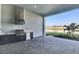 Covered outdoor kitchen featuring a built-in grill and mini fridge at 17903 Palmiste Dr, Bradenton, FL 34202